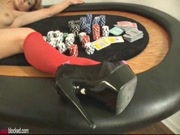 Noel on the poker table wearing red socks and playing with her wand